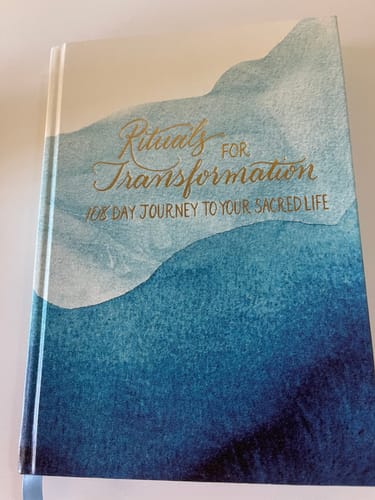 Customer's Rituals for Transformation Guided Journal, showing the blue watercolor hardcover and gold title.