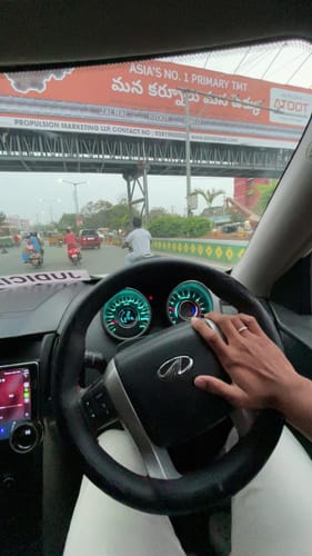 Customer's hand on a car steering wheel, wearing the Silver Classic Chain Ring for Him.