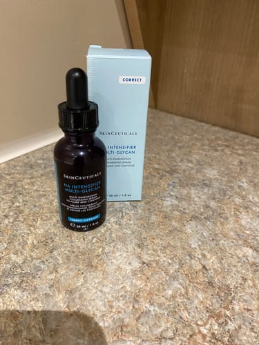 Reviewer's SkinCeuticals HA Intensifier Multi-Glycan serum bottle placed next to its box on a countertop.