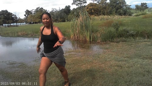 Reviewer's clear video still captured by the Retro Mini Keychain Camera, showing a person outdoors in a park.