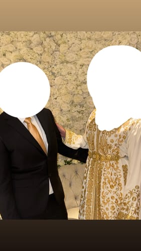 Reviewer wearing the Lebsa Sahla kaftan, highlighting its ornate gold embroidery and matching belt.