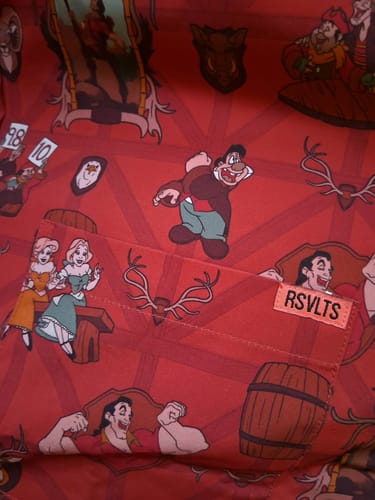 Close-up from a customer of the red 'No One Like Him' shirt, showing the detailed pattern with Gaston and tavern characters.