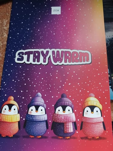Customer's December 2025 Booklet showing a cute cover with four penguins in winter clothes under the words 'STAY WARM'.