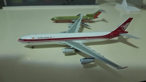 Customer's Air Lanka A340-300 model airplane with its white and red livery sitting on a tabletop.