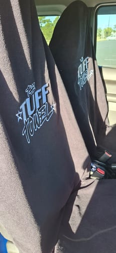 Customer's two black Waterproof Car Towel Seat Covers draped over the front seats inside a vehicle.