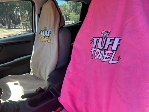 Customer's pink and beige Waterproof Car Towel Seat Covers shown fitted onto the front seats of a vehicle.