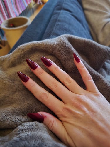 Customer wearing the Red Wine - Press On Nails, showing the long, almond shape.