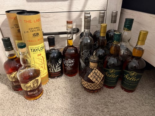 Reviewer's collection of various bourbon bottles that arrived safely, covered by the Shipping Protection service.
