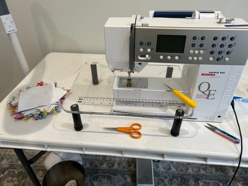 Reviewer's Sew Steady Sewing Machine Extension Table attached to their sewing machine on a work desk.