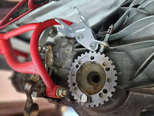 Customer's RIFE Driveshaft Speed Sensor installed with a silver bracket next to a toothed wheel on a vehicle.