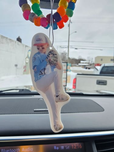 Customer's Custom Air Freshener, shaped like a young baseball player, hanging inside a car from the rearview mirror.