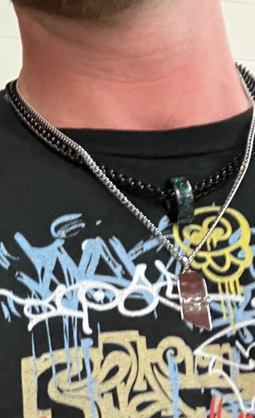 Customer photo review of Broken Skateboard Pendant (Silver)