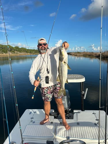 Customer on a boat holding a large fish with the Waterloo Slam Mag fishing rod.