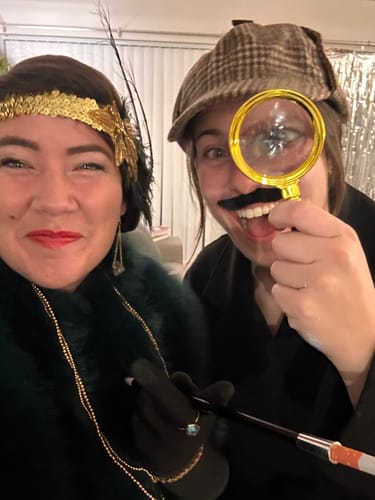 Customers in 1920s flapper and detective costumes having fun playing the Murder Mystery Game.