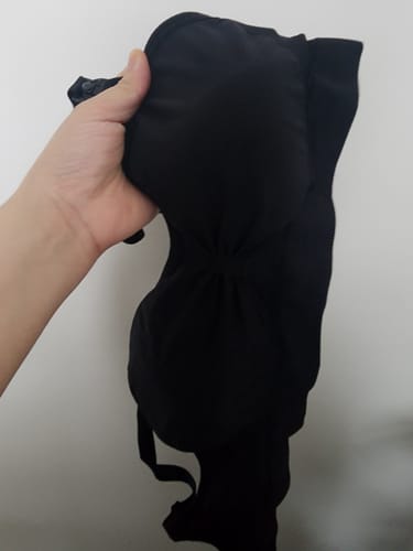 A customer holds up their black Lovemère Seamless Nursing Bra, showing the soft material.