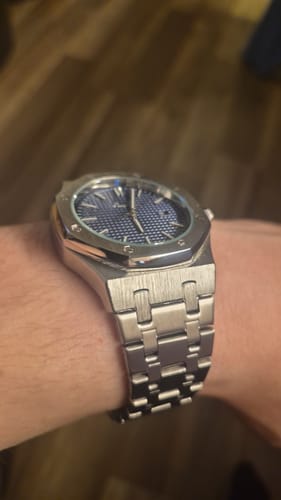 Customer showing their silver Lucky Fours® Oceanus watch with a blue dial on their wrist.