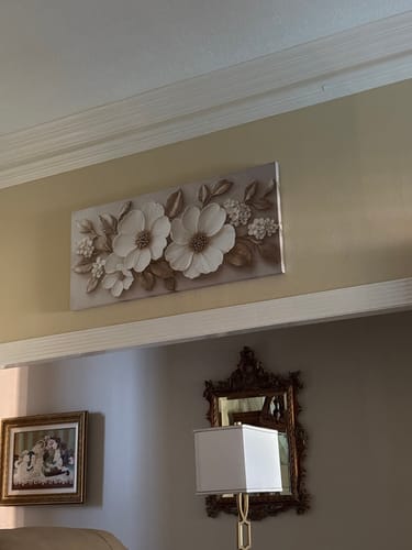 Customer's Modern Blossom Wall Art with textured white and tan flowers hanging on a living room wall.