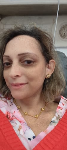 Reviewer wearing the gold Celine Ten Clover Necklace.