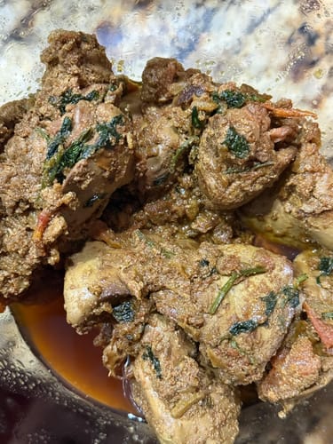 Close-up of a customer's Halal Chicken Liver, cooked into a savory dish with spices.