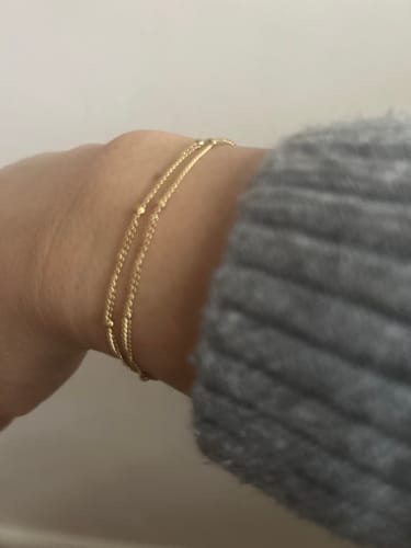 Reviewer wearing the Double Beaded Necklace as a dainty bracelet on their wrist.