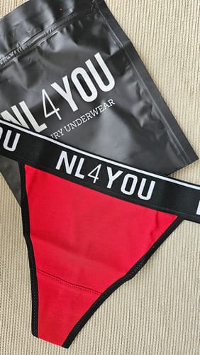 Reviewer's red and black underwear with a branded waistband, laid out next to its black NL4YOU brand packaging.