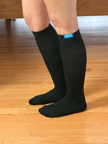 Customer wearing black Performance Eucalyptus Compression Socks, showing the fit from foot to just below the knee.