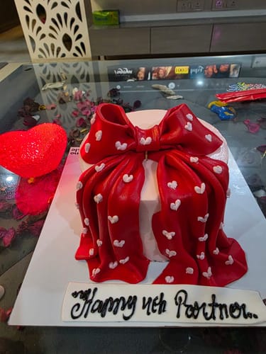 Customer's Vintage Bow n Ribbon Cake with a big red bow covered in white hearts, celebrating an anniversary.