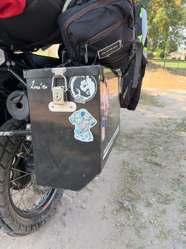Customer's various Cut to Shape Stickers displayed on a black storage box attached to a motorcycle.