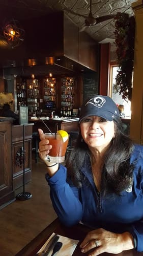 Customer smiling at a restaurant table while wearing the I F♡cking Love You Ring on her finger.