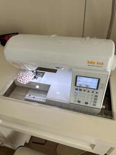 Customer's Sew Steady acrylic cabinet insert fitted perfectly around a Baby Lock sewing machine in a white cabinet.