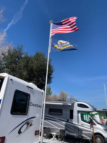 Customer's Heavy Duty American Nylon Flag waving in the wind on a flagpole next to an RV.