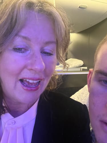 Close-up of a reviewer on a flight, showing her calm skin after using The Miracle Collection.