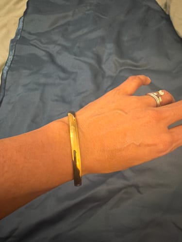 A reviewer's wrist wearing the gold Marbella Cuff Bracelet.