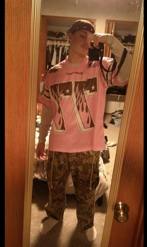 Customer wearing the Pink Flame Print Jersey T-shirt over a long-sleeve shirt in a mirror selfie.