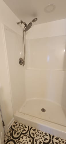 Customer's newly installed metal 3-Spray Dual Shower Head Set in a white shower.