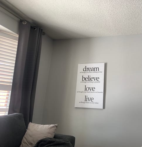 Reviewer's 'Dream, Believe, Love, Live' canvas hung on a light gray wall in their living room.