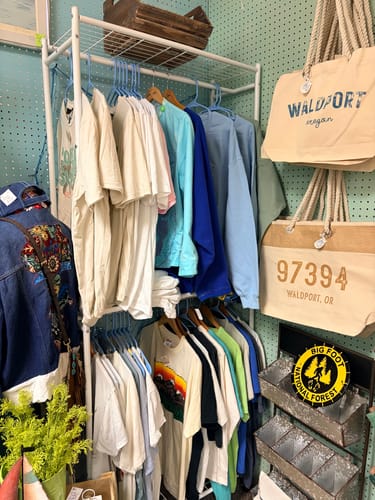 Customer's collection of vintage graphic t-shirts displayed on a white clothing rack.