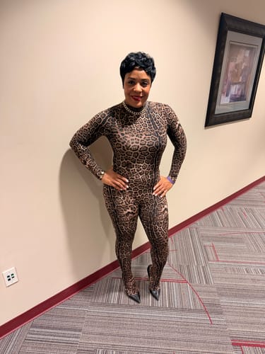 Customer posing from the front in the leopard print Naked Print Closed Toe Jumpsuit.