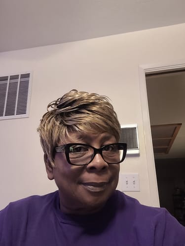 Reviewer smiling while wearing her short, highlighted Vanessa Fashion Full Wig - CALI.