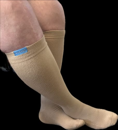 A reviewer's legs wearing the beige, knee-high Performance Eucalyptus Compression Socks.