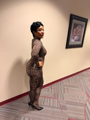 Reviewer showing the side profile of the form-fitting Naked Print Closed Toe Jumpsuit.