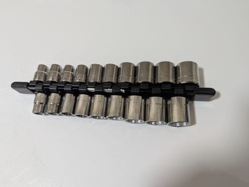 Reviewer's black rail completely filled with sockets using the Extra Socket Holder Clips.