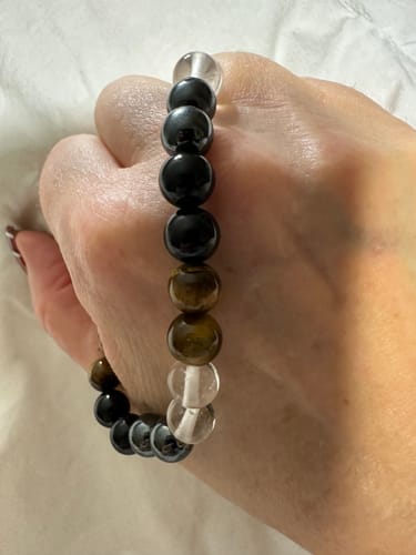 Reviewer's hand holding a crystal bead bracelet from their monthly subscription.