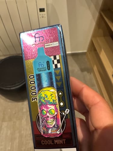 Customer holding the colorful box for the RandM Tornado 30000 vape in Cool Mint flavor.