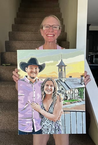 Reviewer holding their completed Custom Paint by Numbers artwork of a smiling couple outdoors.