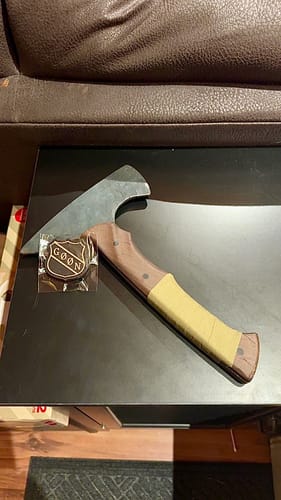 Customer shows the OD Green Raid Tape wrapped around the wooden handle of their tomahawk trainer.