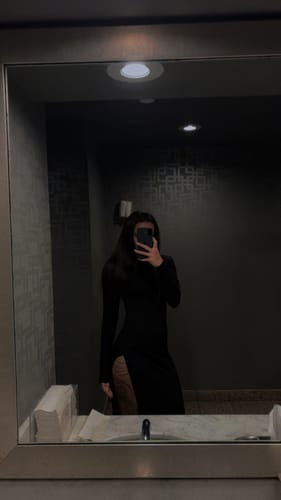 Reviewer's mirror selfie in the black Butter Contour High Slit Maxi Dress, showing the form-fitting style and thigh slit.