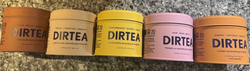 Customer's Reishi Mushroom Powder tin lined up with four other colorful DIRTEA mushroom powder tins.