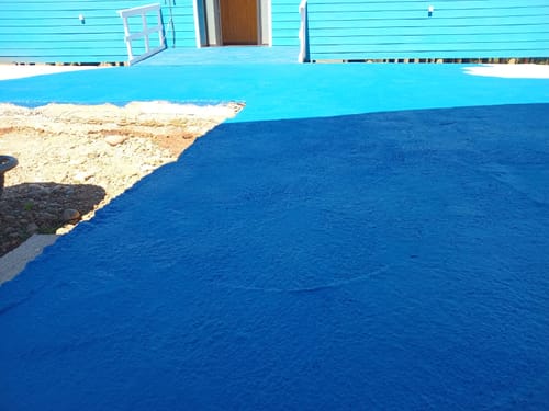 Cliente mostrando el Esmalte Lanco azul brillante aplicado en un sendero de hormigón poroso.