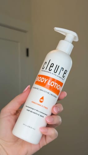 Customer holding the white pump bottle of fragrance-free Body Lotion for sensitive skin.